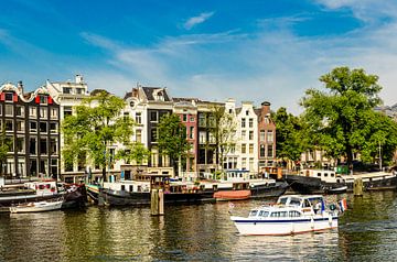 House facades boats and houseboats on canal in Amsterdam city center in Netherlands by Dieter Walther