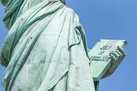 Detail of the Lady Liberty statue, book with the date of USA's independence