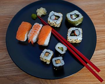 Sushi arranged on a plate with chopsticks by Babetts Bildergalerie