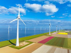 Wind turbines on a levee and offshore during springtime seen fro