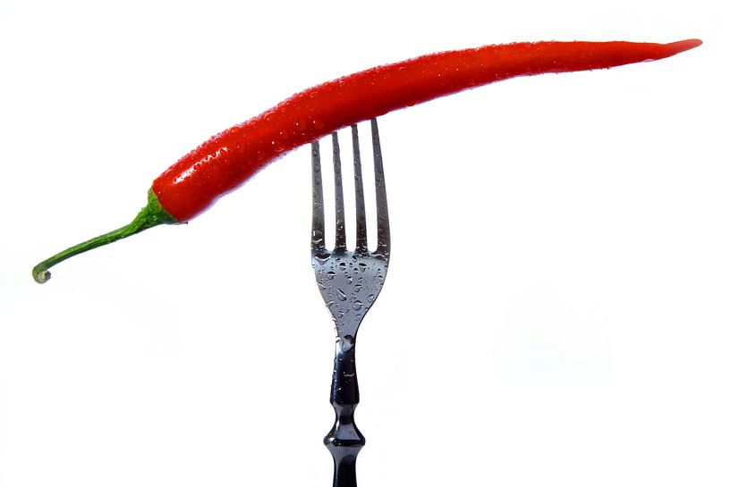 Chilli pepper on a fork by Jürgen Wiesler