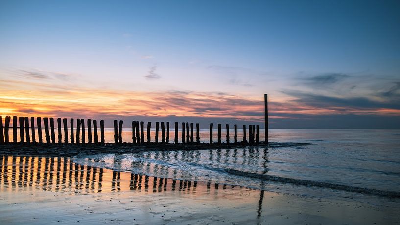 Pole at sunset on the beach by Truus Nijland