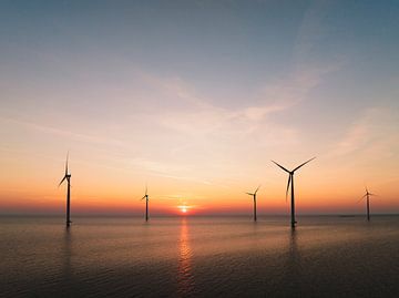 Wind turbines in an offshore wind park during sunset