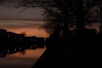 Dawn over the water. Sahara sand in the sky.