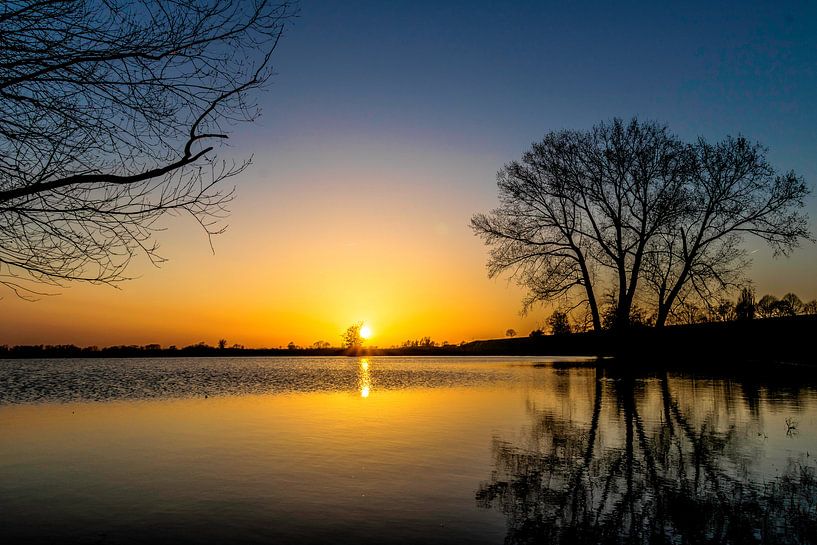 Sunset in the Netherlands by the water by Devlin Jacobs
