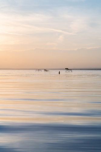 Evening swim walk in the Balaton to the sunset with calm water