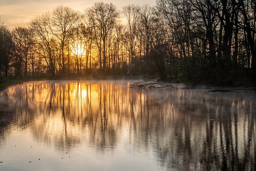 Sunrise and a pond with water vapour by Henk Hulshof