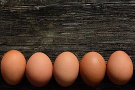 Eier liegen nebeneinander auf Holz von Ulrike Leone