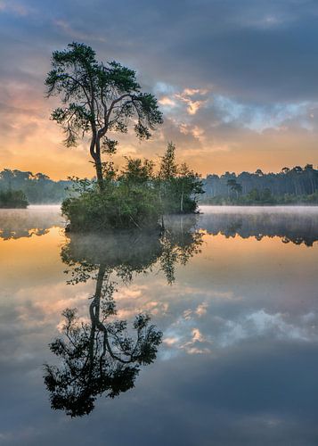Orange and turquoise sunrise reflected in a lake