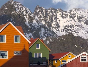Colorful Wooden Houses Nestled Beneath the Snow-Capped Peaks of 