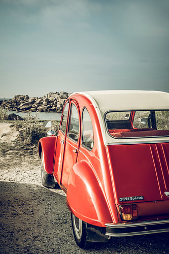 French classic Citroën 2CV car parked at the beach