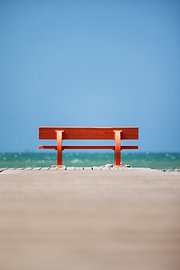 Bench (red) on the beach in France, Normandy by Rob van der Teen