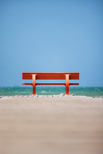 Bench (red) on the beach in France, Normandy