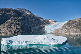 Unique view of an iceberg passing a glacier by Frank's Awesome Travels