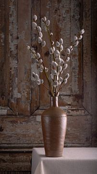 Still life, pitcher with willow cattails (Salix) by rustic old door by Oda Slofstra