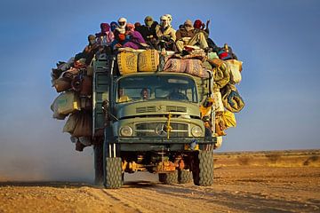 Vrachtwagen met mensen in Sahara woestijn