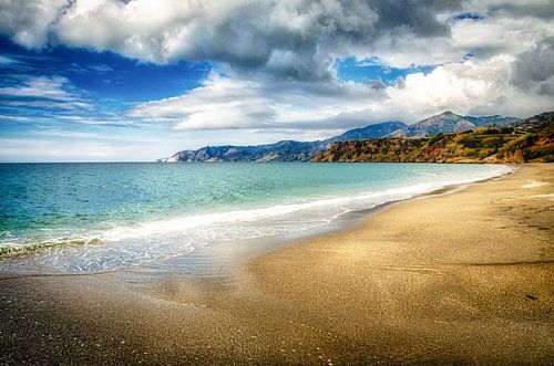 Lonely great sandy beach with mountain range and cloudy nature landscape