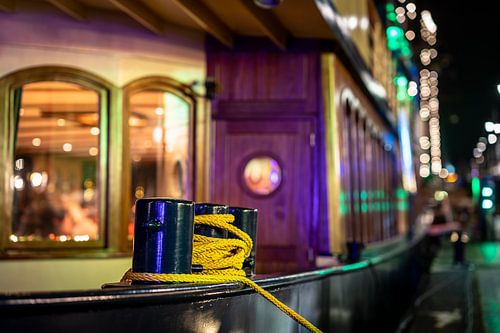 Bollard of a ship in the harbor with the bokeh of patches and colored lighting