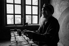 A black and white portrait of the gamelan maestro Ki Suripto on his gamelan in Salatiga, Central Jav by Anges van der Logt