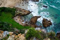 Interplay between sand, rocks and the sea