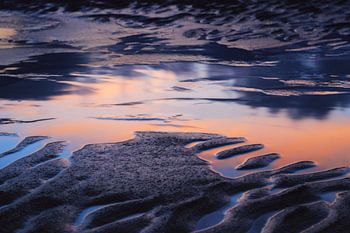 Reflectie op het strand.