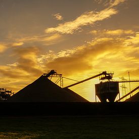 Sand mining industry at sunset by Ton Valk