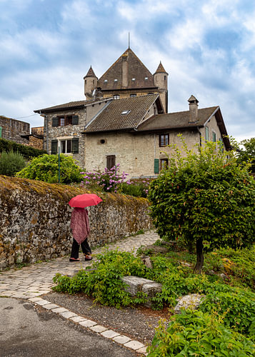 The woman with the red umbrella, on her way to Yvoire Castle