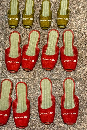 Colourful flip-flops on a floor in Japan by Patricia Hofmeester