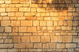 Natural vintage stone background texture covered with sundown light at the wall by Alex Winter