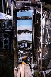 Interior of a DC-3 aircraft wreck with a view of the snow-covered landscape, Eyvindarholt, Iceland by René Wiegmink