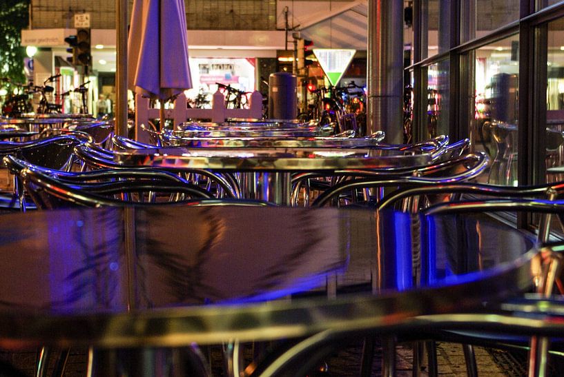 Bistro tables at night by Norbert Sülzner