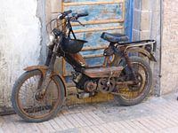 Still life of moped against door, Morocco