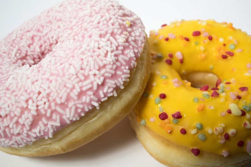 Closeup of delicious sweet glazed donuts with flakes on a white background. Colorful donut. by N. Rotteveel