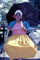 Elderly woman selling peanuts.