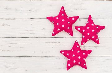 Decoratie met drie roze sterren op wit hout met kopieerruimte van Alex Winter