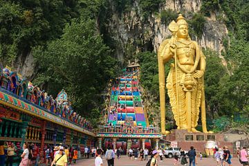 Lord Murugan with prayer wheels and stairs in front of the Batu Caves by kall3bu