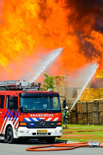 Fire engine in front of a fire in an industrial area by Sjoerd van der Wal Photography