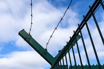Close up of barbed wire on border fence by MPfoto71