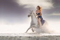 Girl on horseback through the surf