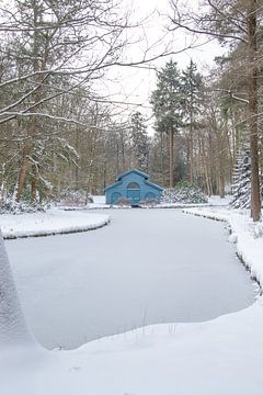 Blue boathouse in the snow by Hans Monasso
