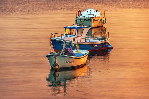 Three boats in the setting sun
