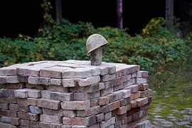stacked bricks and old construction helmet on a building site