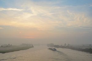 Ship in a sunrise over the river IJssel during a beautiful fall 