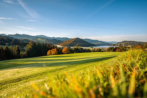First rays of sunshine in autumn with a view of the Hochgrat, Staufen and Oberstaufen