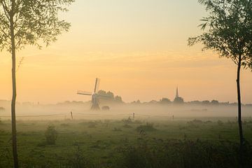 Dutch morning with windmill, church tower and fog! by Corné Ouwehand