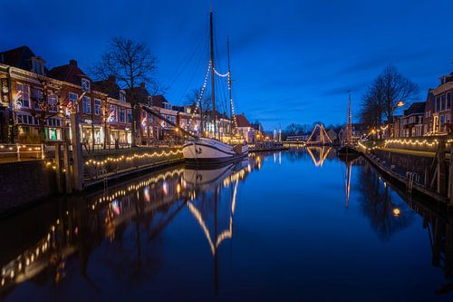 Dokkum with illuminated boats in the water