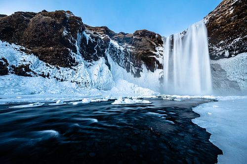 The Skogafoss waterfall in a winter landscape (Iceland)