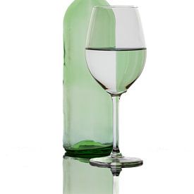 Reflections of a coloured bottle in a wine glass by Roland Brack