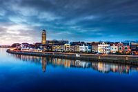 Clouds above city view of Deventer and the Welle with reflection and traffic.