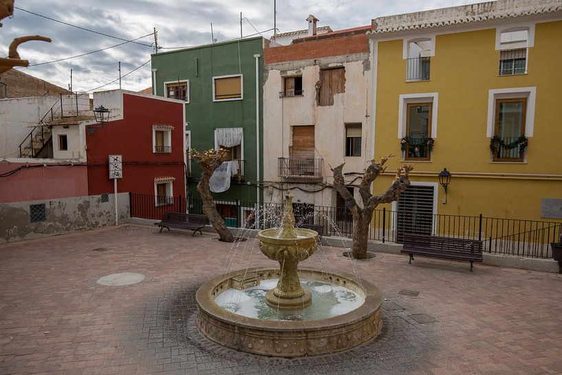 Square with fountain in the village of Joiosa, Alicante, Spain by Joost Adriaanse